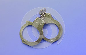 Bdsm and sex games concept. Handcuffs on blue background