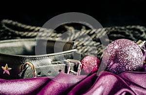 bdsm still life leather collar shibari rope and christmas ball on pink cloth close up