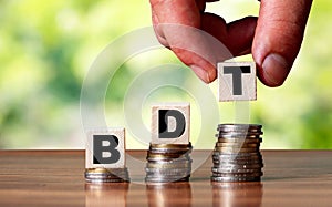 BDT bangladeshi taka word symbol - business concept. Hands put wooden block