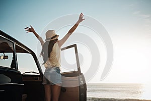 Be as free as the ocean. a young woman enjoying a road trip along the coast.