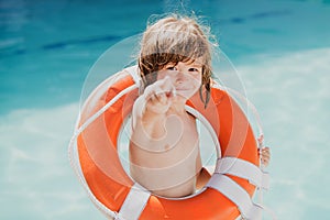 Be careful on water. Kids saving life. Helping concept. Child with rescue circle. Summer beach. photo