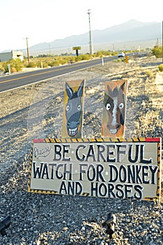 Be Careful of wild donkey and horses road sign along side highway Pahrump, Nevada, USA