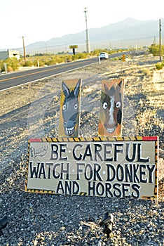 Be Careful of wild donkey and horses road sign along side highway Pahrump, Nevada, USA