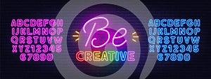 Be creative neon inspirational quote on a brick wall.