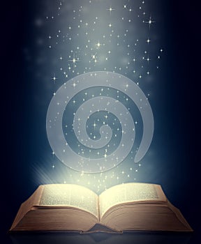 Be drawn into new worlds. Shot of an open storybook with light emanating from it.