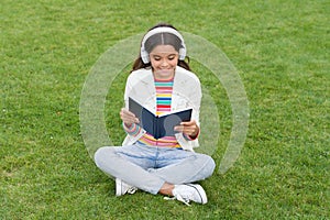 Be a good achiever. knowledge day. future school education. teen girl with book on green grass. pretty child little girl