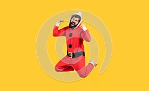 Be happy. jumping bearded man in christmas costume. concept of freedom. happy male has funny look. winter holiday party