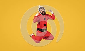 Be happy. jumping bearded man in christmas costume. concept of freedom. happy male has funny look. winter holiday party