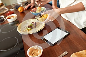 Be healthier. Close up of process of cooking. Woman preparing healthy meal in the kitchen checking recipe using tablet