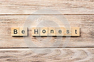 Be honest word written on wood block. be honest text on table, concept
