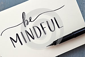 BE MINDFUL hand-lettered in notepad with brush pen