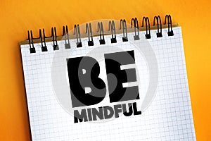 Be Mindful text quote on notepad, concept background