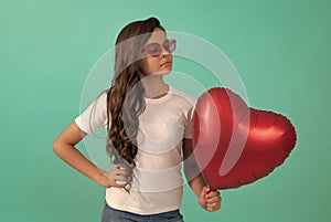 be my valentine. teen girl with party balloon. love present. serious kid with love romantic gift