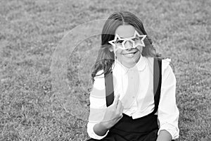 Be nice. childhood happiness. back to school. funny kid in park. relax on green grass with glasses. cheerful child ready