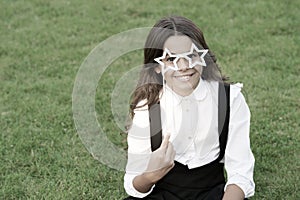 Be nice. childhood happiness. back to school. funny kid in park. relax on green grass with glasses. cheerful child ready