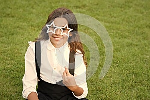 Be nice. childhood happiness. back to school. funny kid in park. relax on green grass with glasses. cheerful child ready