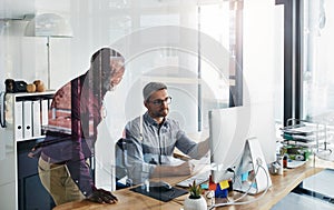 Always be open to critique. two businesspeople working on a computer in an office.