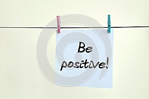 Be positive! Note is written on a white sticker that hangs with