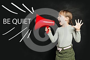 Be quiet concept. Funny little girl screaming loudly through a megaphone Be quiet