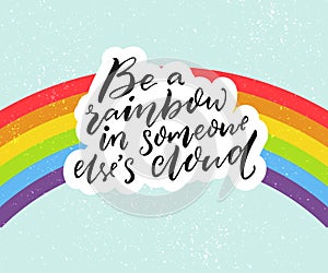 Be a rainbow in someone else`s cloud. Positive inspiration quote with rainbow at blue sky background