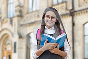 Be a reader. Happy kid hold library book outdoors. School library. Reading and literacy education. Bibliotheca. Cute