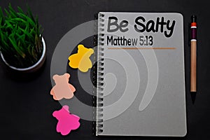 Be Salty - Matthew 5:13 write on a book  on office desk. Christian faith concept