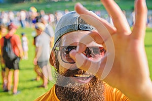 Be sure in your summer vacation. Man bearded in front of crowd riverside background. Book ticket summer festival in