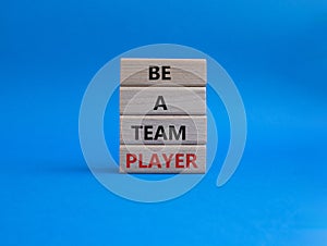 Be a team player symbol. Concept words Be a team player on wooden blocks. Beautiful blue background. Business and Be a team player