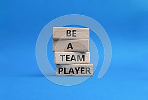 Be a team player symbol. Concept words Be a team player on wooden blocks. Beautiful blue background. Business and Be a team player