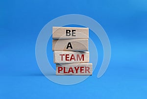 Be a team player symbol. Concept words Be a team player on wooden blocks. Beautiful blue background. Business and Be a team player