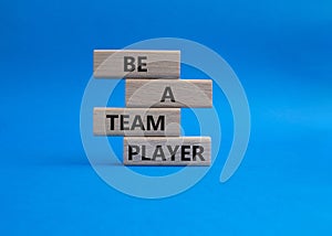 Be a team player symbol. Concept words Be a team player on wooden blocks. Beautiful blue background. Business and Be a team player