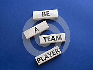 Be a team player symbol. Concept words Be a team player on wooden blocks. Beautiful deep blue background. Business and Be a team