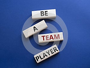 Be a team player symbol. Concept words Be a team player on wooden blocks. Beautiful deep blue background. Business and Be a team