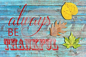 Always be thankful on blue wooden background
