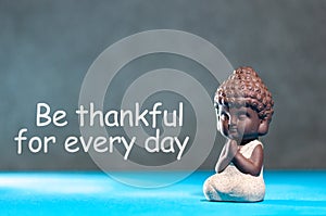 Be Thankful for every day - inspirational and motivating text near little buddha figurine