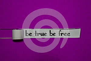 Be True Be Free, Inspiration, Motivation and business concept on purple torn paper photo