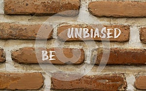 Be unbiased symbol. Concept words Be unbiased on red brown brick wall. Beautiful red brown brick wall background. Business