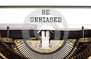 Be unbiased symbol. Concept words Be unbiased typed on white paper on old retro typewriter. Beautiful white background. Business