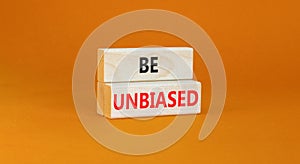 Be unbiased symbol. Concept words Be unbiased on wooden block. Beautiful orange table orange background. Business psychology be