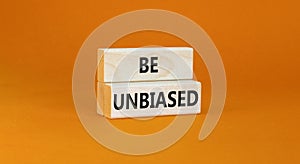 Be unbiased symbol. Concept words Be unbiased on wooden block. Beautiful orange table orange background. Business psychology be