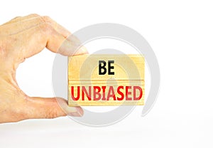 Be unbiased symbol. Concept words Be unbiased on wooden block. Beautiful white table white background. Businessman hand. Business