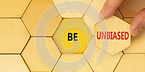 Be unbiased symbol. Concept words Be unbiased on wooden puzzles. Beautiful yellow table yellow background. Businessman hand.