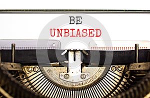 Be unbiased symbol. Concept words Be unbiased typed on white paper on old retro typewriter. Beautiful white background. Business photo