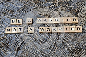 be a warrior not a worrier text on wooden square, motivation quotes