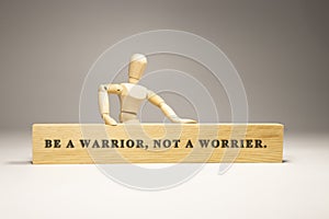 Be a warrior, not a worrier written on wooden surface. Motivation and personal development