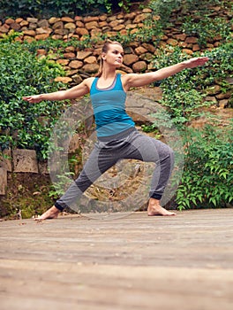 Be a warrior not a worrier. a young woman practicing yoga outdoors.