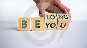 Be you  belong symbol. Businessman changes words 'be you' to 'belong'.