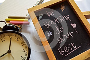 Be your best friend phrase colorful handwritten on chalkboard, alarm clock with motivation and education concepts.