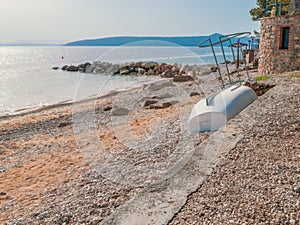 Beach and abandoned fishing boat, Adriatic Sea coast, place to relax in Moscenicka draga, Istria, Croatia. Beautiful