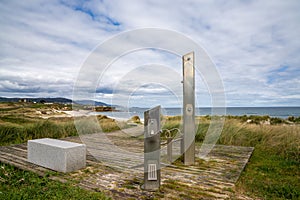 Beach access with shower and wooden boardwalk on the coast of Galicia photo